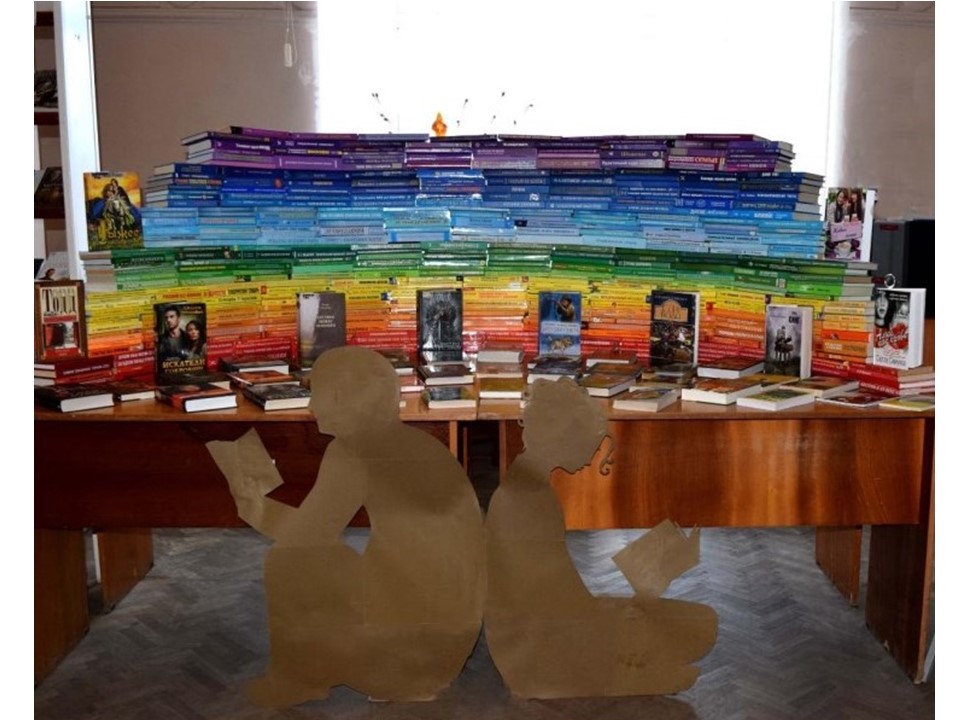 книжная инсталяция, книги выложены по цветам радуги