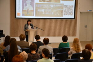 Директор владимирской областной библиотеки для детей и молодежи выступает за трибуной на не презентации доклада